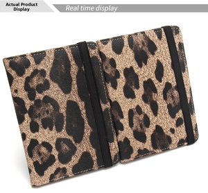 Detail view of leopard print PU leather passport holder with elastic closure bands