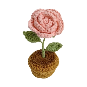 Handmade crochet pink rose potted plant with green leaves and a brown woven pot