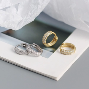Close-up of gold and silver S925 sterling silver hoop earrings with triple row zircons
