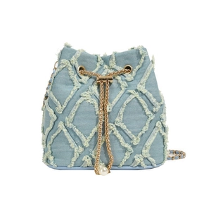 Close-up of light blue denim bucket bag with frayed diamond pattern and pearl chain detail