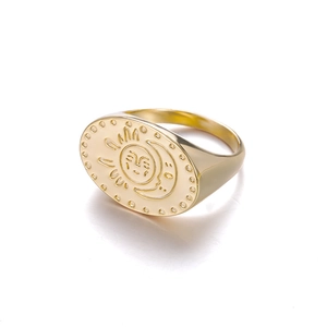 Detail showing vintage gold signet ring with engraved sun and moon celestial motif