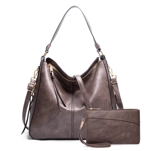 Detail view of large faux leather hobo bag and matching wristlet in vintage coffee brown