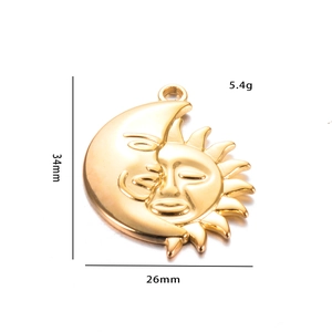Macro detail of sun and moon face pendant showing 34mm x 26mm dimensions and gold finish