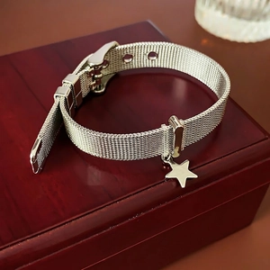 Silver Milanese star charm bracelet with adjustable buckle and woven mesh texture