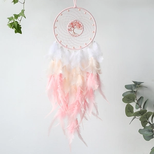 Detail of pink tree of life dreamcatcher with crystals and soft gradient feathers