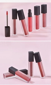 Close-up of matte square tube lip mud with plush applicator on soft pink background