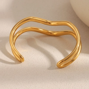 Detailed view of dual-layer wavy 18K gold plated stainless steel cuff bracelet