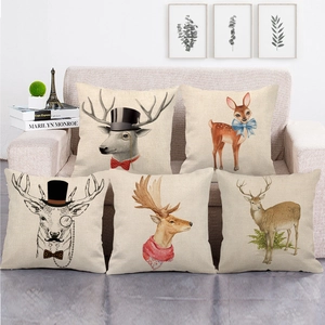 Set of five linen pillow covers with vintage hand-drawn elk portraits on a sofa