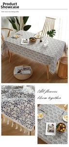 Detail of blue and white vintage floral cotton linen tablecloth with elegant white tassels