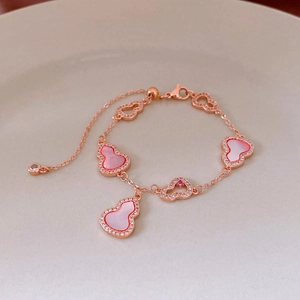 Detail of rose gold bracelet with pink mother of pearl and zircon hollow gourds