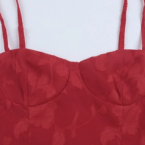 Detailed view of red floral jacquard fabric on a bustier dress with adjustable thin straps