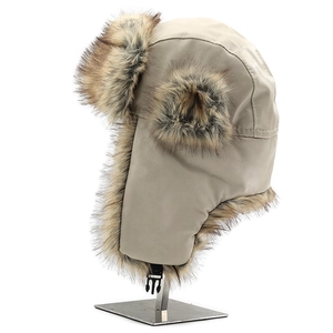 Detail of beige faux leather trapper hat with warm brown faux fur lining and buckle