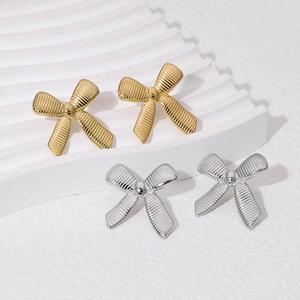 Chic 18k gold and silver stainless steel bow earrings with a textured striped finish