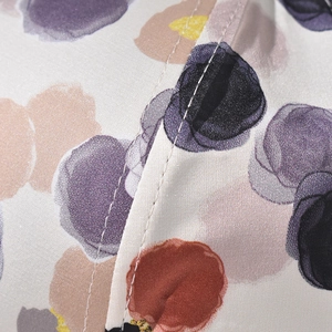 Macro detail of twill fabric baseball cap with colorful watercolor polka dot pattern