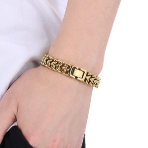 Close-up of a gold Franco chain bracelet with a heavy dragon bone link design and box clasp