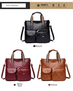 Three large multi-pocket crossbody bags shown in black, burgundy, and tan with striped handles