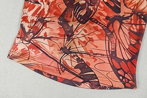 Detail of red-brown butterfly print on knit fabric with double-needle hem stitching