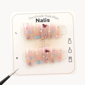 Handmade press-on nails with blue French tips, colorful star sequins and pink rhinestones