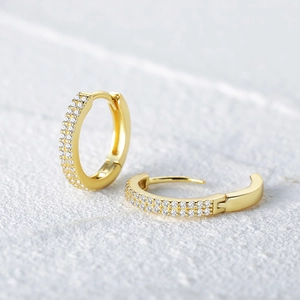 Macro shot of S925 silver wave hoop earrings with double-row sparkling zircon crystals