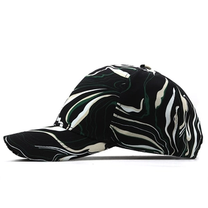 Detail of outdoor baseball cap with black, white and green marble vortex pattern texture
