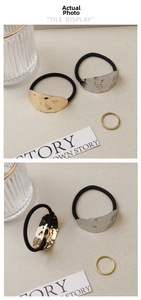 Detail of gold and silver hair ties with hammered alloy texture and black elastic band