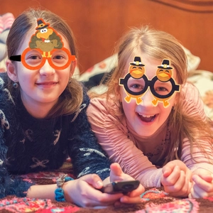 Funny Thanksgiving turkey party glasses worn by two girls for festive photo props