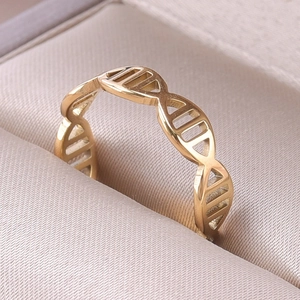 Macro shot of a golden DNA double helix open ring inside a champagne jewelry box