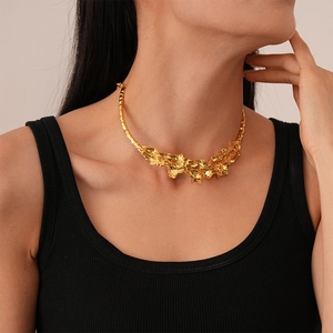 Detail of gold wrinkled leaf chain collar necklace with irregular molten metal texture