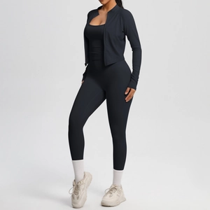 Detailed view of women's black three-piece yoga set including jacket, sports bra, and leggings