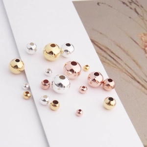 Detailed view of assorted S925 sterling silver beads in gold and rose gold for DIY jewelry