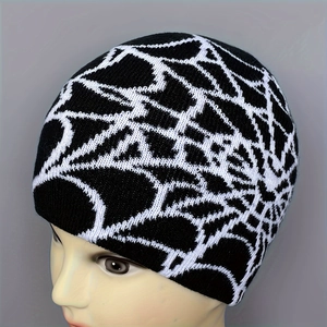 Jacquard knitted beanie with classic black and white spider web pattern for winter warmth
