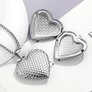 Vintage heart locket necklace in stainless steel with detailed floral relief engraving