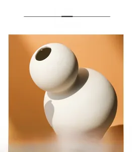 Detailed macro view of the smooth round mouth on a white matte ceramic bud vase