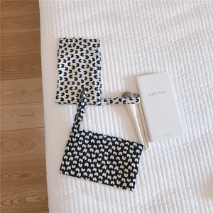Detailed view of quilted cotton mini tote bags with white bow patterns for storage