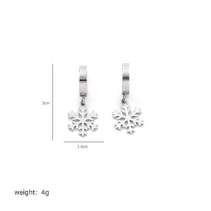 Detail view of silver snowflake drop earrings with size measurements of 3cm and 1.3cm