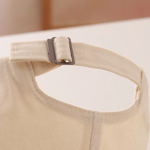 Detail view of adjustable metal buckle and twill cotton strap on children baseball cap