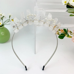 Macro shot of silver crown headband with raw crystals, pearls, and rhinestones