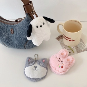 Detail of cute plush cartoon animal mirrors with metal bead chains on a denim bag