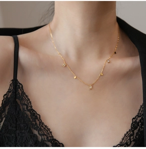 Detail of elegant gold fringe necklace with square crystals on model neck