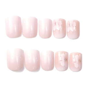 Short square press-on nails with pink gradient, white flowers and polka dot patterns