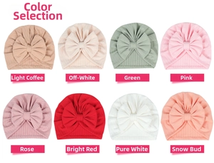 Close-up of ribbed knit baby hats in eight pastel colors with cute bow details