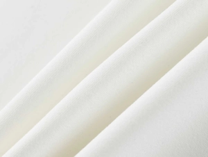 Macro shot of white moisture-wicking fabric showing soft texture and fine knit fibers