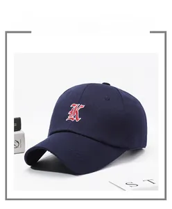 Macro shot of navy blue baseball cap with 3D letter K embroidery and stitched brim