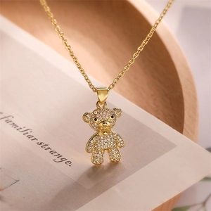 Detailed close-up of a gold teddy bear pendant necklace with sparkling pavé crystals