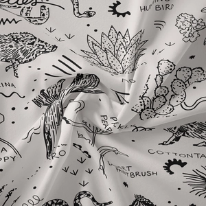 Detail showing soft cotton fabric texture and black desert illustration print