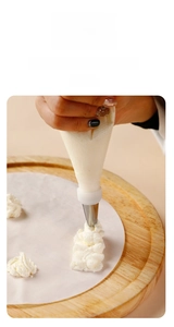 Close-up of thick disposable pastry bag squeezing cream batter for baking cookies