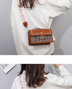 Detail of vintage square bag with tweed splicing and ethnic embroidery wide strap