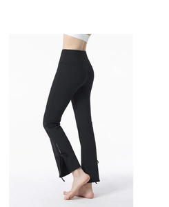 Close-up of flare yoga pants leg with side slit and delicate black bow tie detail