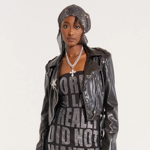 Close-up of sparkling rhinestone headpiece and cuban chain with cross pendant accessory