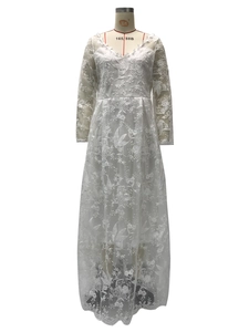 Close-up of elegant white floral embroidery and sheer lace sleeves on a bridal gown